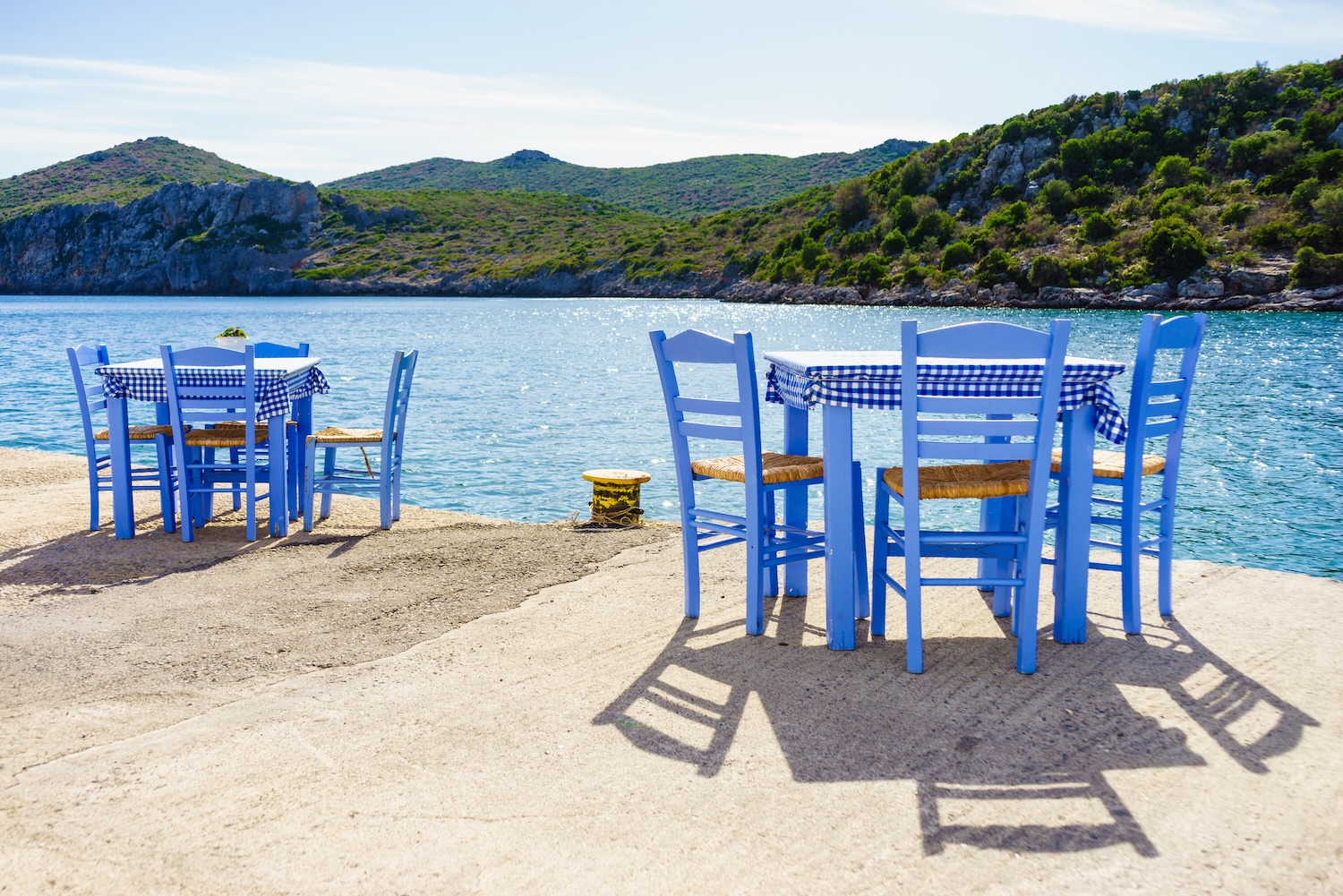 Open cafe outdoor restaurant in Greece on sea shore